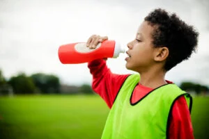 Students taking a hydration break during physical education class