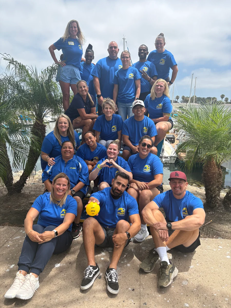 SPARK Institute attendees in matching blue shirts at Mission Bay, San Diego