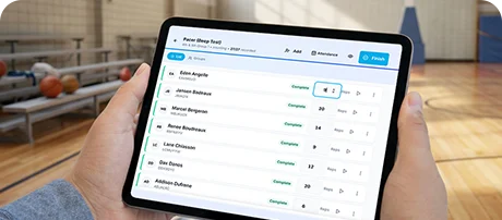 Assess with SPARK Digital – teacher using tablet to track student progress in gym